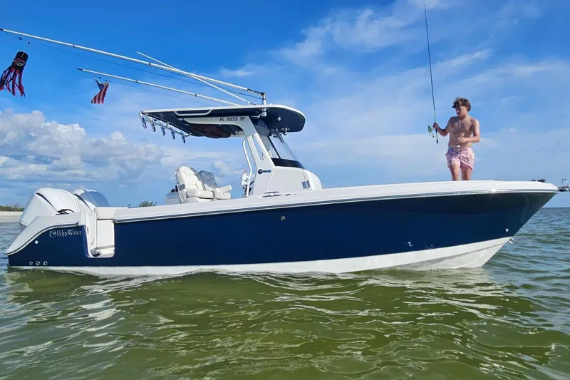 Slide: The Image of 2023 Edgewater 262CC boat with person fishing, set against a clear blue sky. - 7