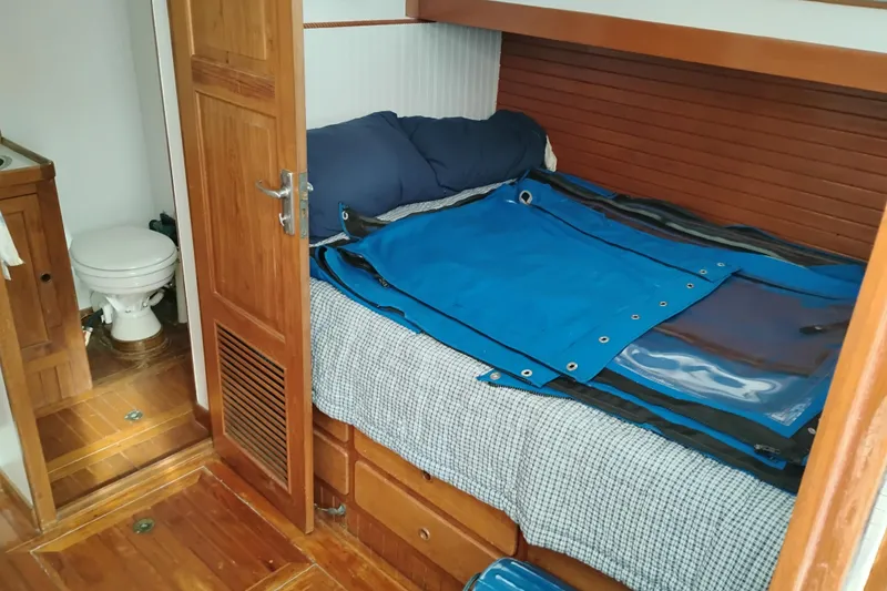 Slide: The Image of 1979 Transpac Eagle 36 Trawler cabin interior with bed and bathroom. - 11