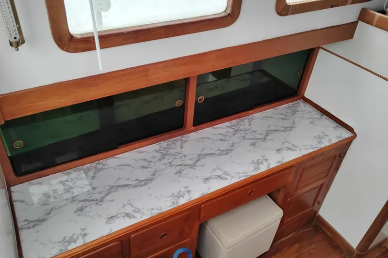 Slide: The Image of 1979 Transpac Eagle 36 Trawler interior with marble countertop and wooden cabinetry. - 15