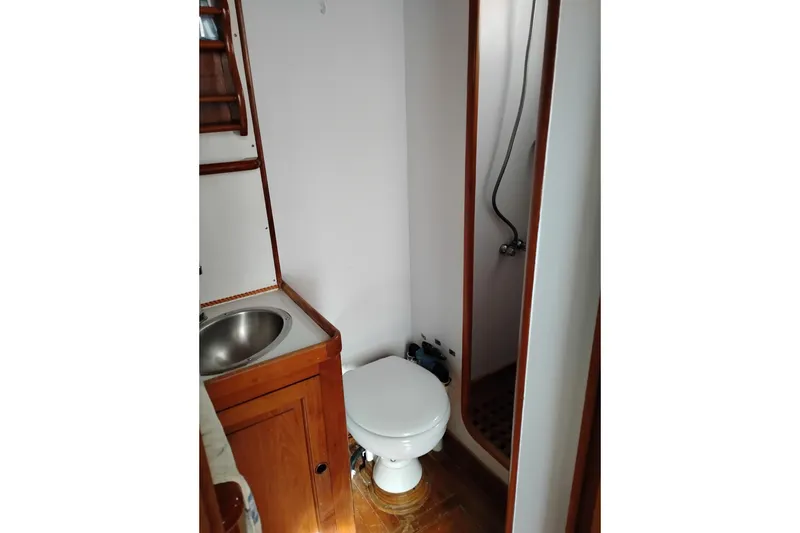 Slide: The Image of 1979 Transpac Eagle 36 Trawler bathroom with sink, toilet, and shower. - 16