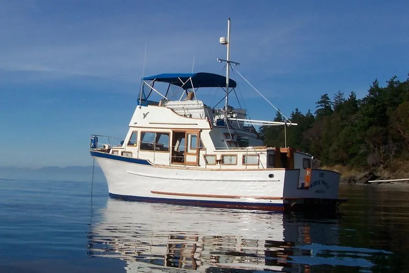 Slide: The Image of 1979 Transpac Eagle 36 Trawler on calm water with clear blue sky. - 2