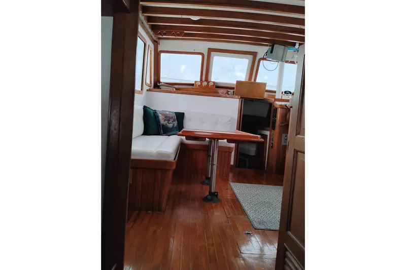 Slide: The Image of Interior of 1979 Transpac Eagle 36 Trawler with wooden finishes and cozy seating area. - 20