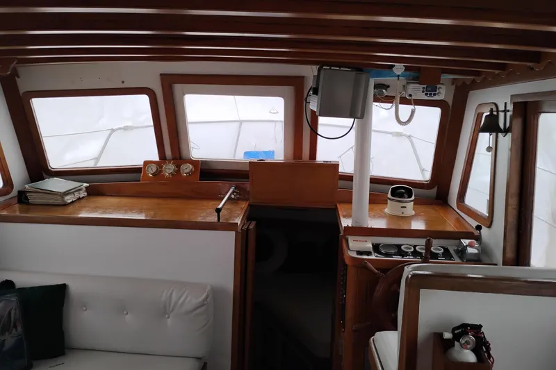 Slide: The Image of 1979 Transpac Eagle 36 Trawler interior with wooden accents and navigation equipment. - 21