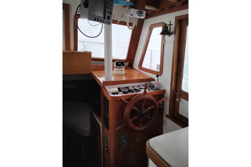 Slide: The Image of 1979 Transpac Eagle 36 Trawler helm with wooden wheel and navigation equipment. - 22