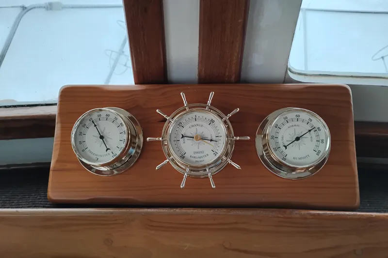Slide: The Image of Wooden panel with thermometer, barometer, and hygrometer on a 1979 Transpac Eagle 36 Trawler. - 27