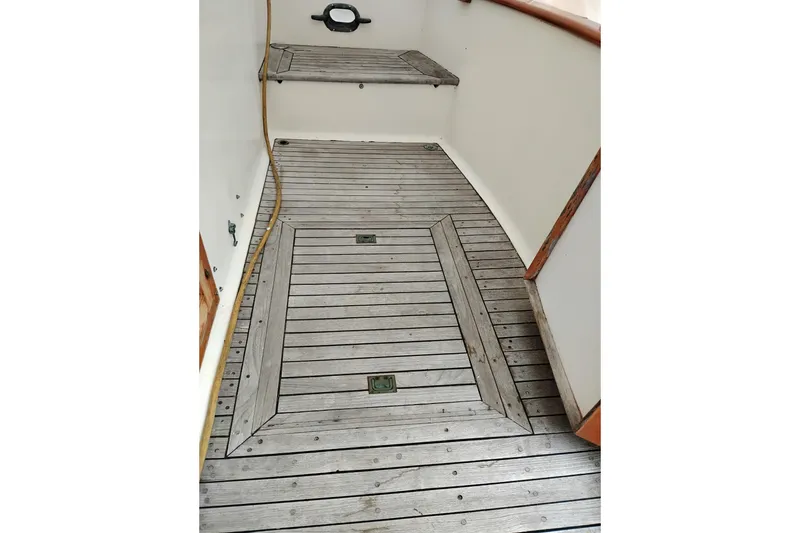 Slide: The Image of Wooden deck of a 1979 Transpac Eagle 36 Trawler, featuring a classic nautical design. - 3