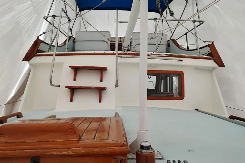 Slide: The Image of 1979 Transpac Eagle 36 Trawler deck view with wooden accents and blue canopy. - 4