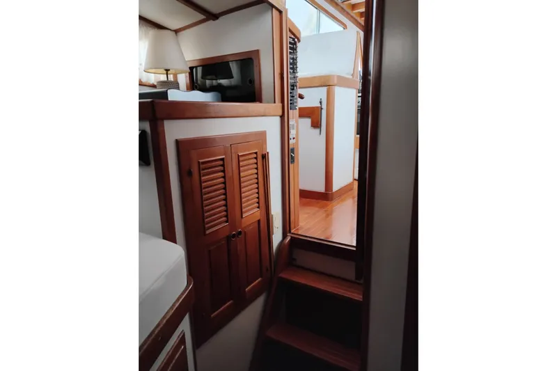Slide: The Image of Interior of 1979 Transpac Eagle 36 Trawler with wooden cabinetry and stairs. - 40