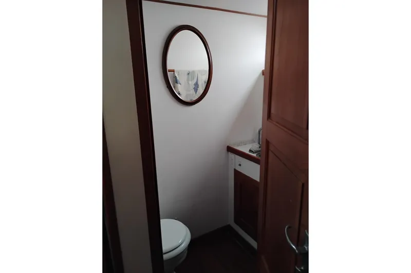 Slide: The Image of 1979 Transpac Eagle 36 Trawler bathroom with mirror and wooden cabinetry. - 41