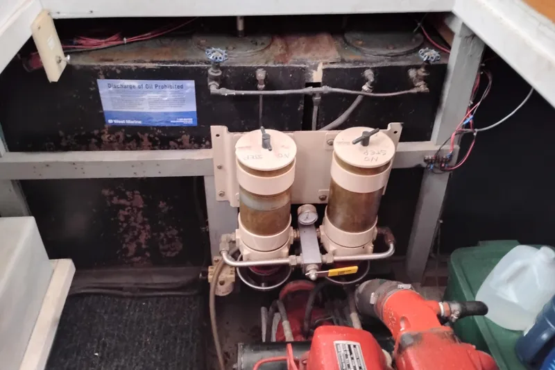 Slide: The Image of Engine room of a 1979 Transpac Eagle 36 Trawler with fuel filters and wiring. - 49