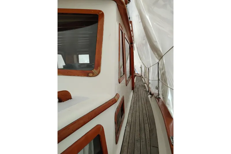 Slide: The Image of 1979 Transpac Eagle 36 Trawler deck with wooden trim and covered walkway. - 52