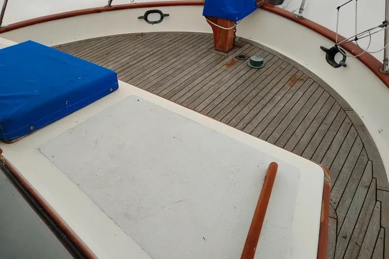 Slide: The Image of 1979 Transpac Eagle 36 Trawler deck with wooden finish and blue covers. - 53