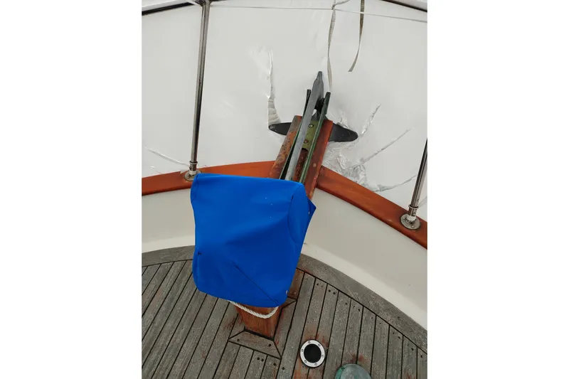 Slide: The Image of 1979 Transpac Eagle 36 Trawler deck with blue cover and anchor detail. - 54