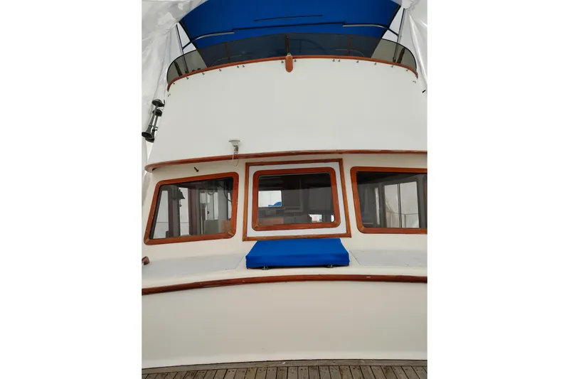 Slide: The Image of 1979 Transpac Eagle 36 Trawler with blue canopy and wooden accents. - 55