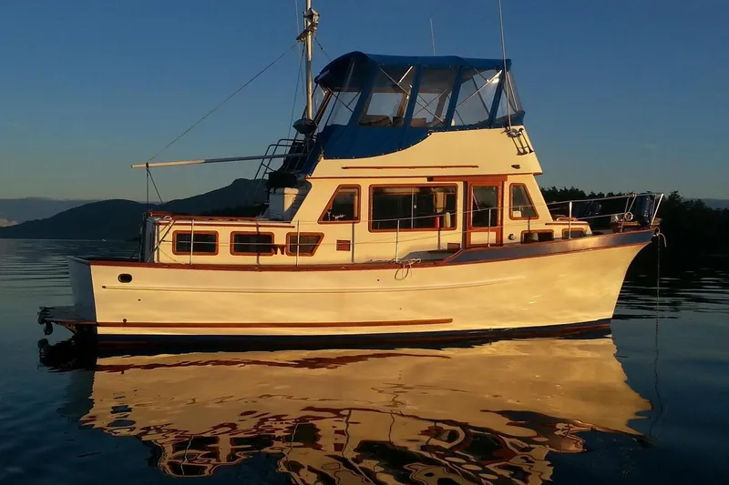 Slide: The Image of 1979 Transpac Eagle 36 Trawler on calm water at sunset. - 56