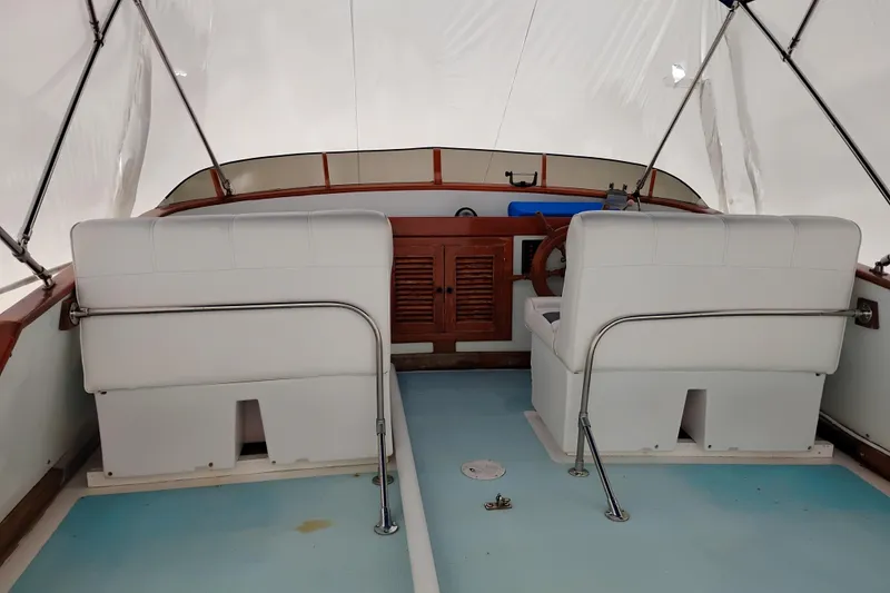 Slide: The Image of 1979 Transpac Eagle 36 Trawler interior with white seating and wooden dashboard. - 6