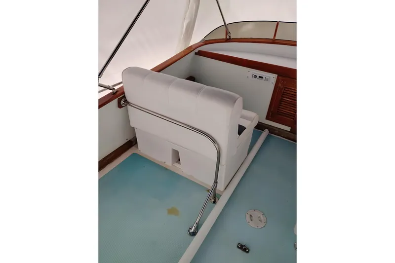 Slide: The Image of 1979 Transpac Eagle 36 Trawler interior with white seating and blue flooring. - 7