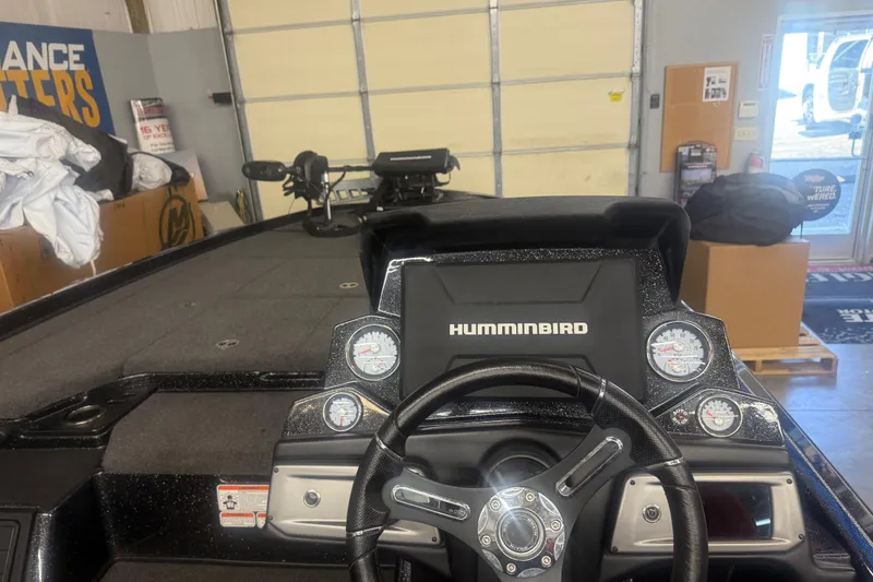 Slide: The Image of 2021 Nitro Z21 Pro boat dashboard with Humminbird display and gauges in a garage setting. - 11