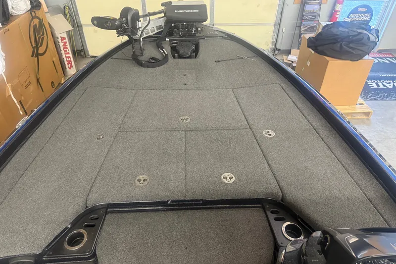 Slide: The Image of 2021 Nitro Z21 Pro boat deck with carpeted surface and fishing equipment. - 12