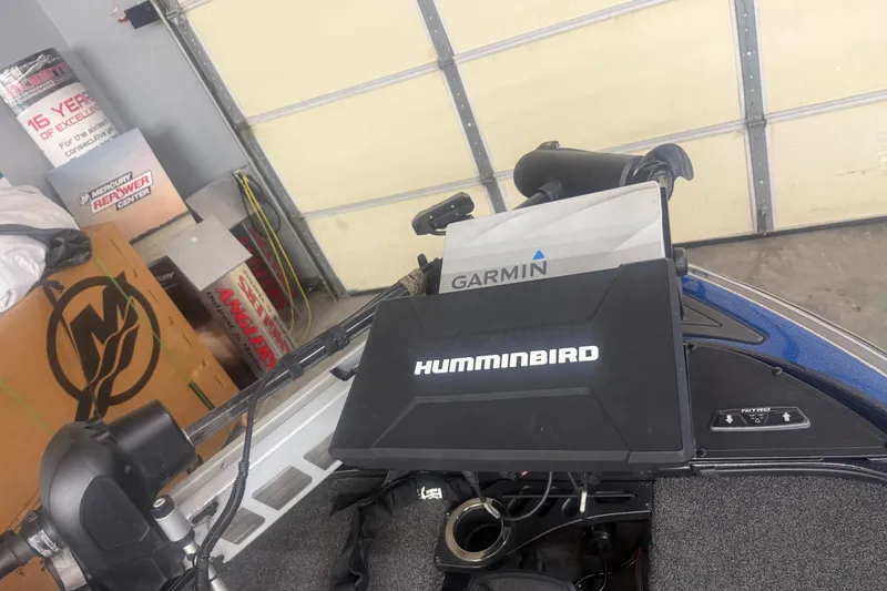 Slide: The Image of 2021 Nitro Z21 Pro boat with Humminbird and Garmin electronics in a garage setting. - 5