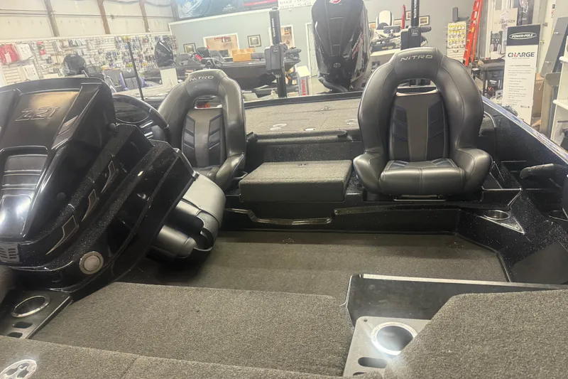 Slide: The Image of 2021 Nitro Z21 Pro boat interior with black leather seats in a showroom. - 8