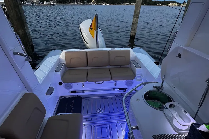Slide: The Image of 2023 Flexboat Flex 680 Explorer interior with seating and ambient lighting on the water. - 11