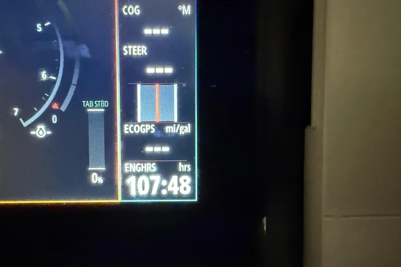 Slide: The Image of Dashboard display of Flexboat Flex 680 Explorer, showing 107:48 engine hours. - 18