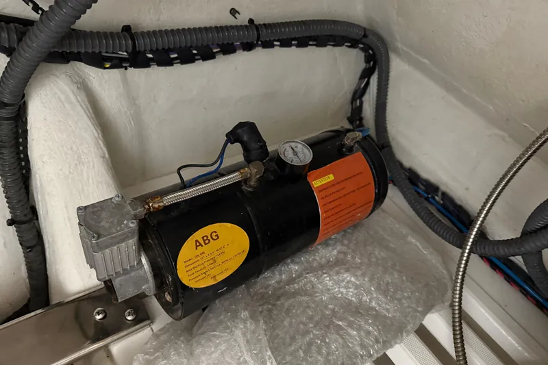 Slide: The Image of Boat engine component in a 2023 Flexboat Flex 680 Explorer, featuring wiring and pressure gauge. - 24