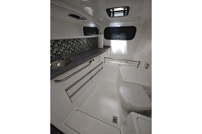 Slide: The Image of Interior of 2023 Flexboat Flex 680 Explorer, featuring modern bathroom with sink and toilet. - 27