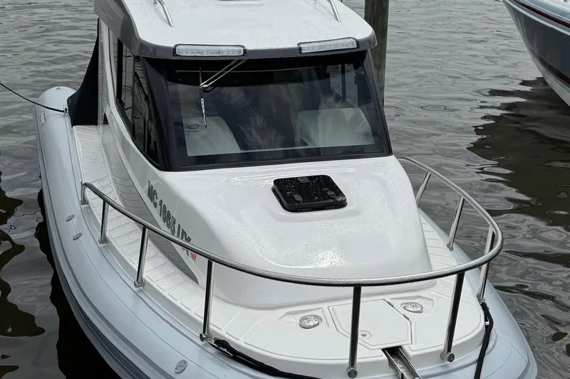 Slide: The Image of 2023 Flexboat Flex 680 Explorer docked on water, showcasing sleek design and modern features. - 3