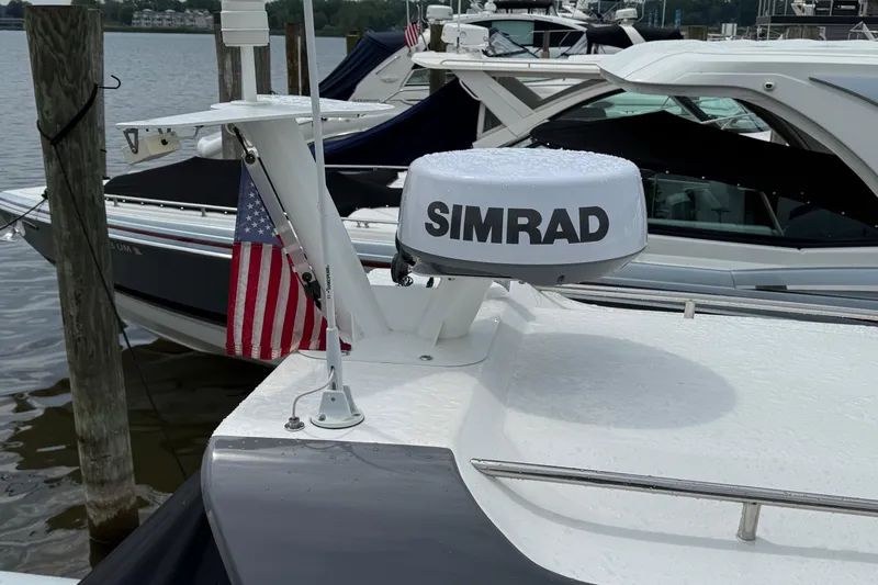 Slide: The Image of 2023 Flexboat Flex 680 Explorer with Simrad radar and American flag at marina. - 7
