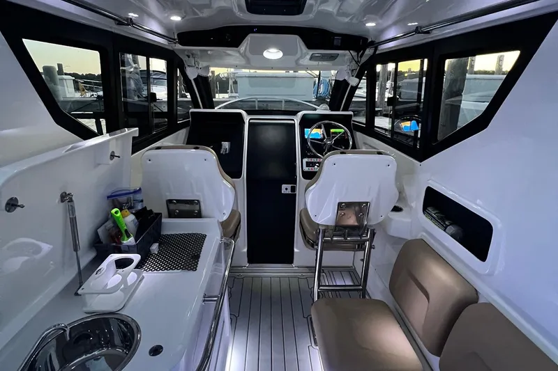 Slide: The Image of Interior of 2023 Flexboat Flex 680 Explorer, featuring modern helm and seating area. - 9