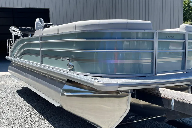 Slide: The Image of 2026 Harris Cruiser 230 pontoon boat, sleek design, docked outdoors. - 12