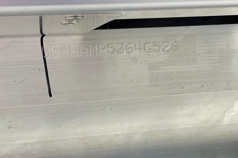 Slide: The Image of 2026 Harris Cruiser 230 hull identification number on metallic surface. - 13