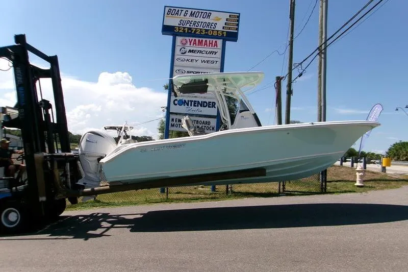The Image of 2026 Key West 239 FS boat lifted by forklift at dealership. - 0
