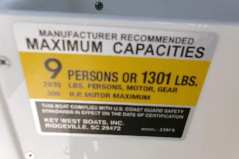 Slide: The Image of Key West 239 FS 2026 boat capacity label: 9 persons or 1301 lbs. - 15