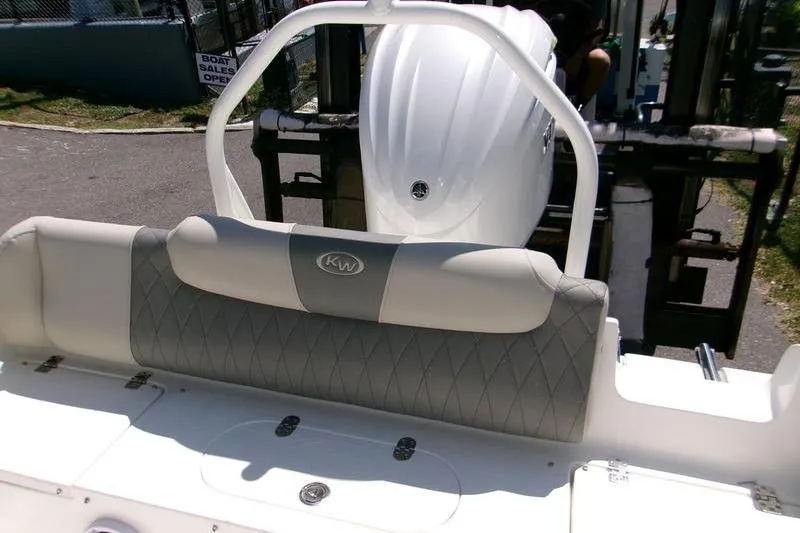 Slide: The Image of 2026 Key West 239 FS boat interior with cushioned seating and visible engine. - 7