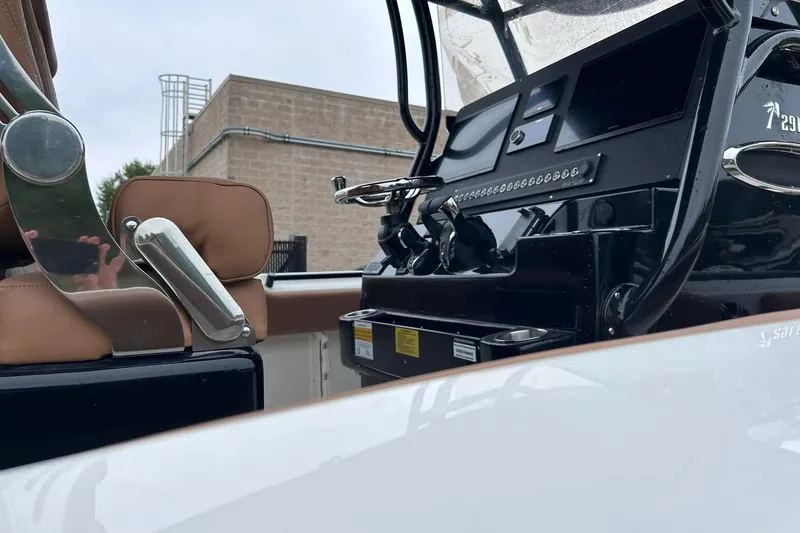 Slide: The Image of 2026 Key West 291 FS boat interior with modern controls and brown seating. - 3