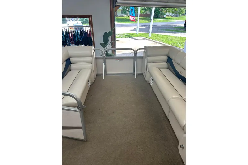 Slide: The Image of Interior of a 2005 Manitou 22 Oasis pontoon boat with beige seating. - 3