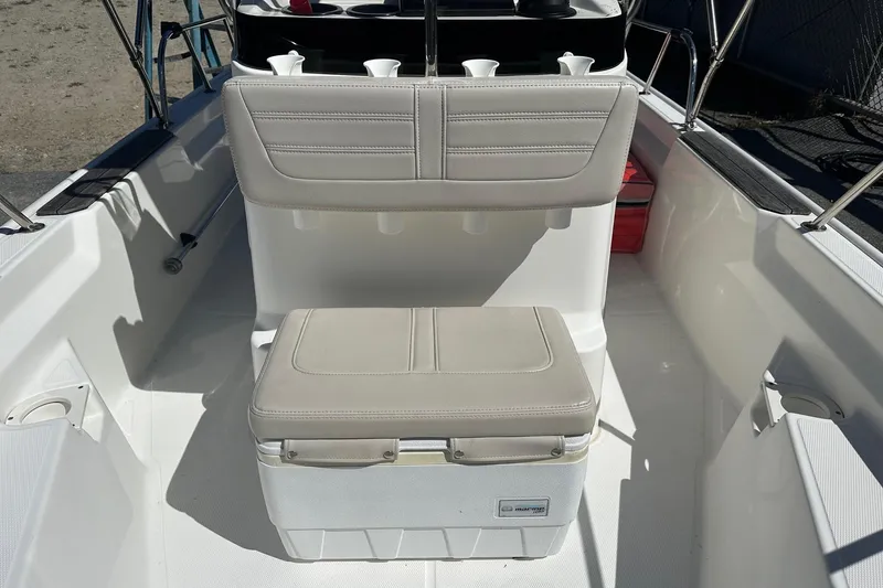 Slide: The Image of 2019 Boston Whaler 150 Montauk boat interior with seating and storage. - 5