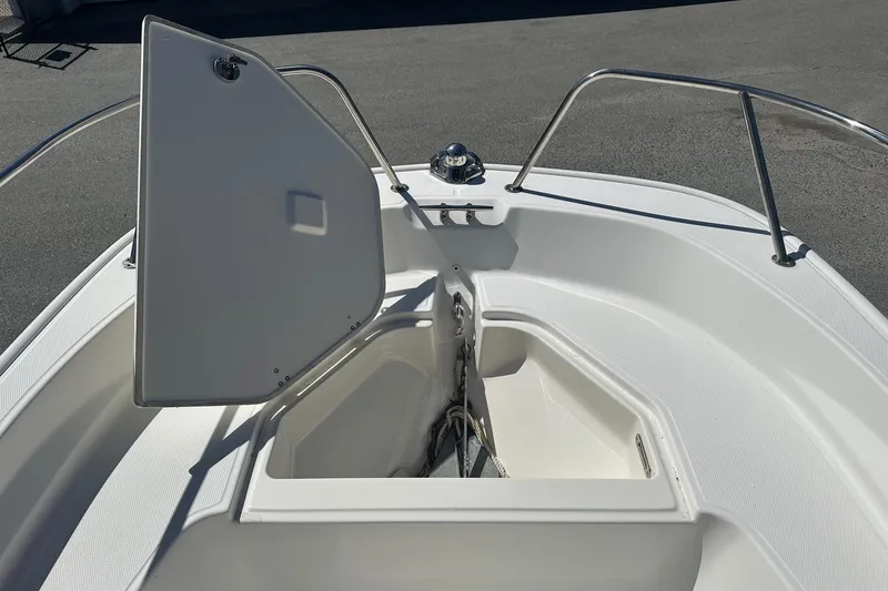Slide: The Image of 2019 Boston Whaler 150 Montauk boat with open storage compartment on deck. - 8