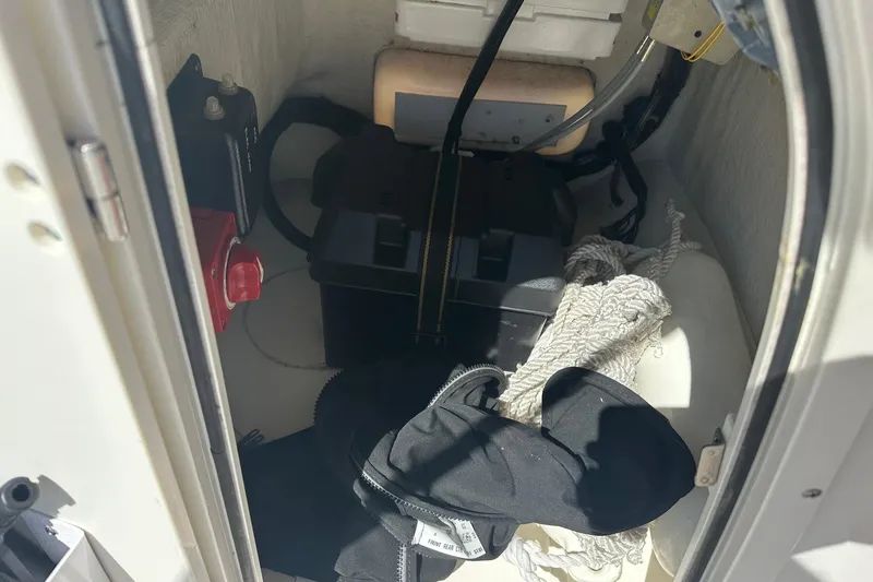 Slide: The Image of Storage compartment of a 2019 Boston Whaler 150 Montauk with boating equipment. - 9