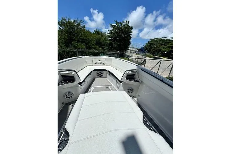 Slide: The Image of 2019 Nor-Teck 390 Sport Center Console boat with spacious seating and clear blue sky. - 13