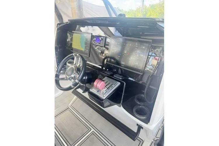Slide: The Image of 2019 Nor-Teck 390 Sport Center Console dashboard with advanced navigation displays and controls. - 23