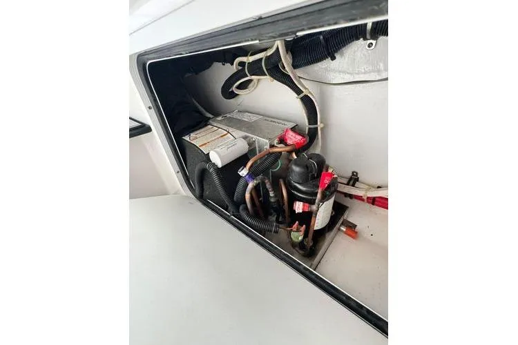 Slide: The Image of 2019 Nor-Teck 390 Sport Center Console electrical compartment with wiring and components. - 31