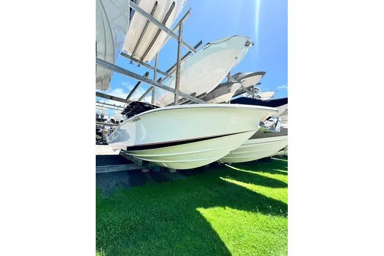 Slide: The Image of 2019 Nor-Teck 390 Sport Center Console boat on display, sunny day, green grass. - 7