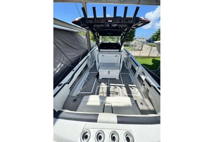 Slide: The Image of 2019 Nor-Teck 390 Sport Center Console boat, spacious deck, sleek design, outdoor setting. - 8