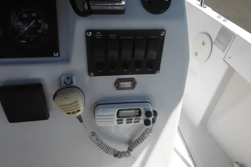 Slide: The Image of 1996 Boston Whaler Outrage 17 dashboard with radio and control panel. - 11