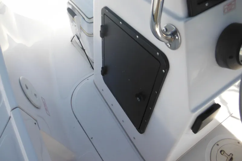 Slide: The Image of 1996 Boston Whaler Outrage 17 boat interior with storage compartment and handle. - 13