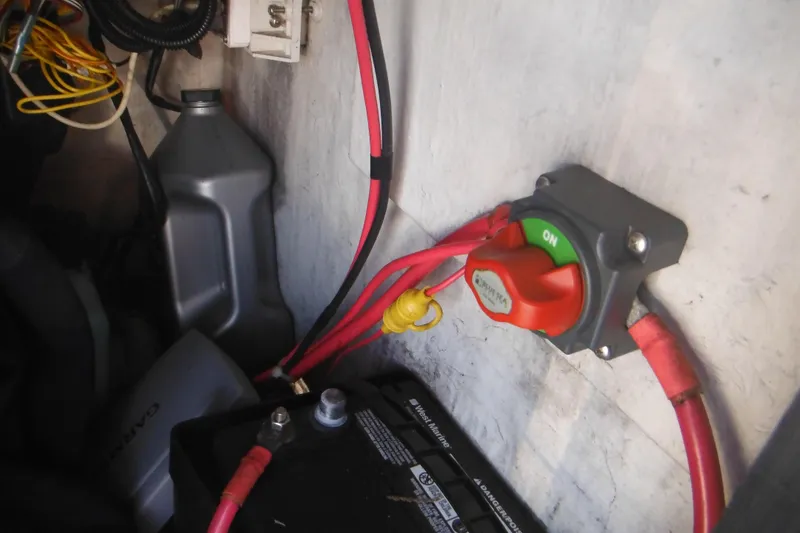Slide: The Image of Battery compartment of a 1996 Boston Whaler Outrage 17 with power switch and cables. - 15